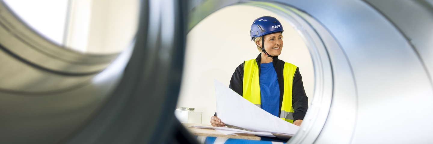 Construction site photo shoot session Experience Center EC High resolution Woman drawing duct Annica Pettersson
